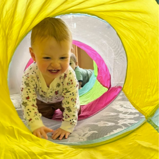 infant crawling through tunnel