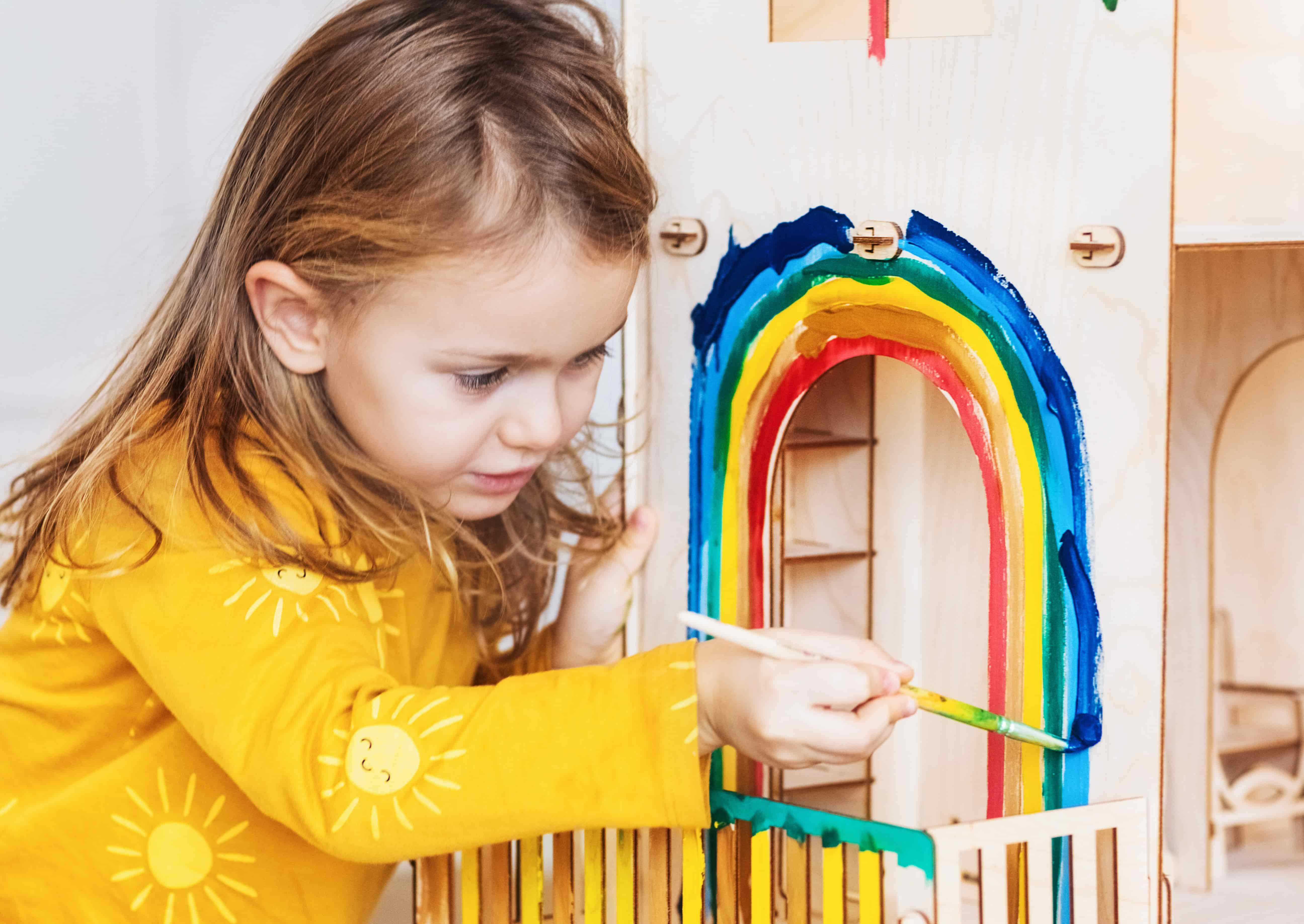 child-girl-decorating-wooden-doll-house-painting-r-2023-11-27-05-30-56-utc (1)
